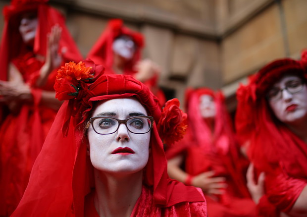 Red Rebels degli Extinction Rebellion in una manifestazione a Sydney (foto d'archivio) © EPA