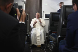 Pope Francis holds a news conference aboard the papal plane