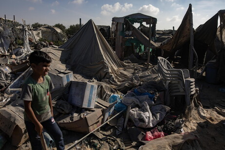 Palestinians inspect the damage following Israeli shelling