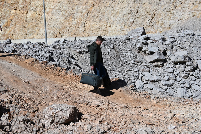 People walk at Masnaa border crossing damaged by Israeli military strike in Lebanon