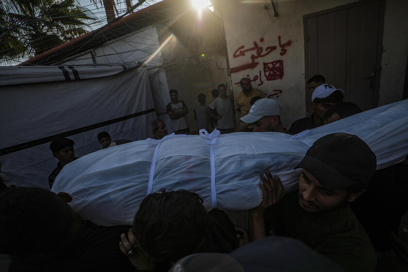 Palestinians mourn their dead after Israeli strike on mosque in Deir al-Balah, central Gaza