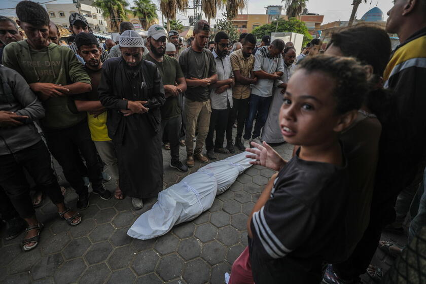 Palestinians mourn their dead after Israeli strike on mosque in Deir al-Balah, central Gaza