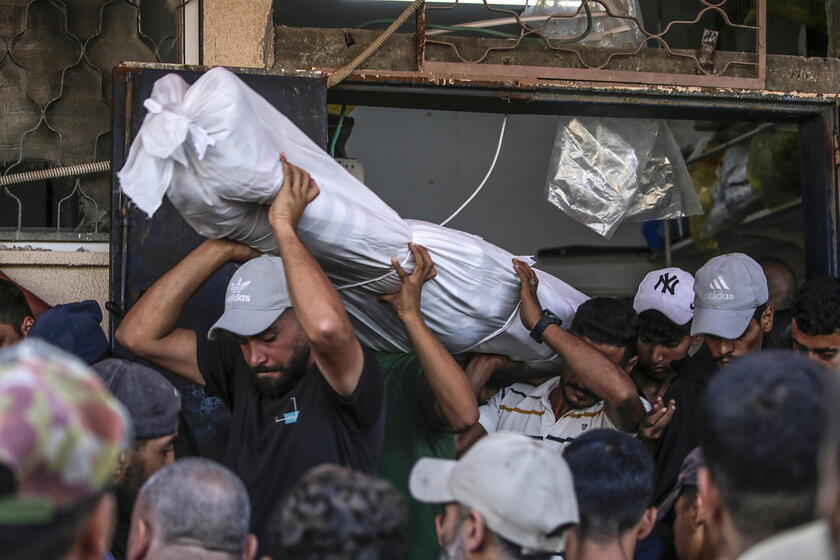 Palestinians mourn their dead after Israeli strike on mosque in Deir al-Balah, central Gaza