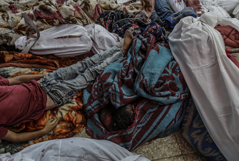 Palestinians mourn their dead following Israeli airstrikes on Gaza's Al Bureij refugee camp