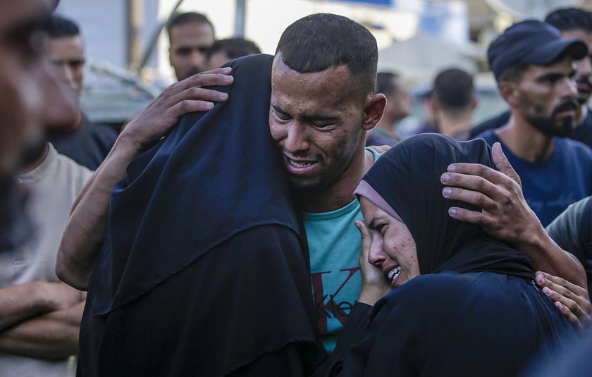 Palestinians mourn their dead following Israeli airstrikes on Gaza's Al Bureij refugee camp