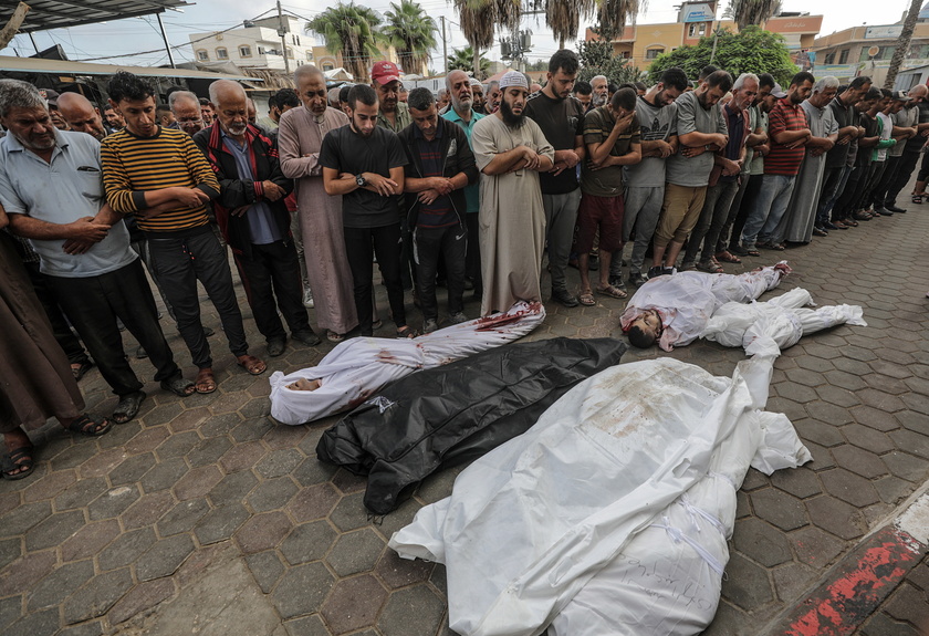 Palestinians mourn their dead following Israeli airstrikes on Gaza's Al Bureij refugee camp