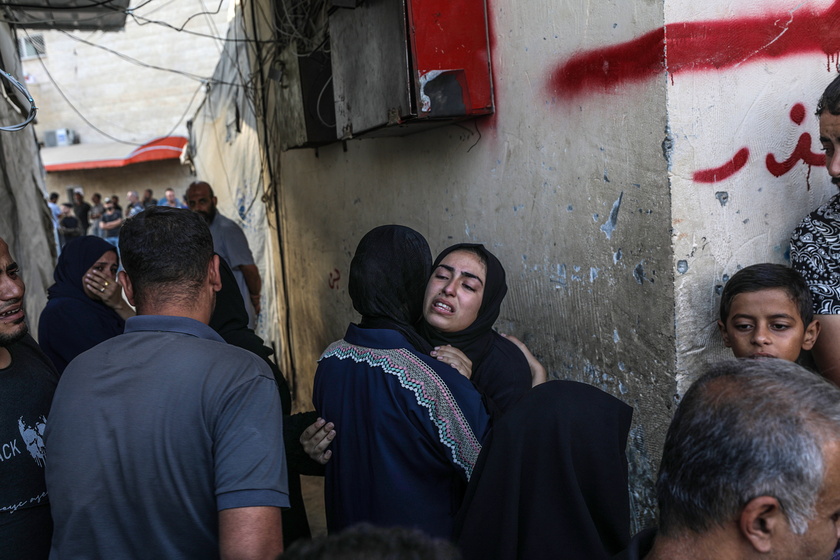 Palestinians mourn their dead following Israeli airstrikes on Gaza's Al Bureij refugee camp