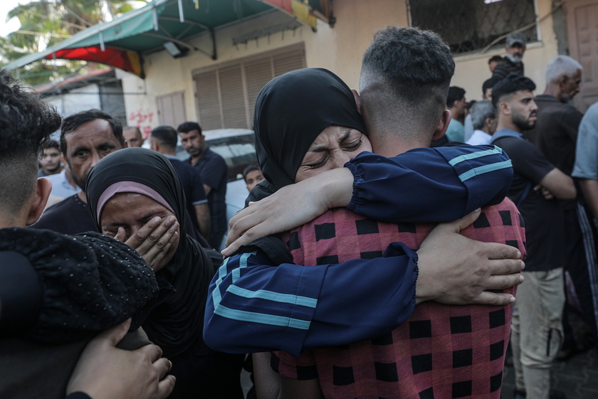 Palestinians mourn their dead following Israeli airstrikes on Gaza's Al Bureij refugee camp