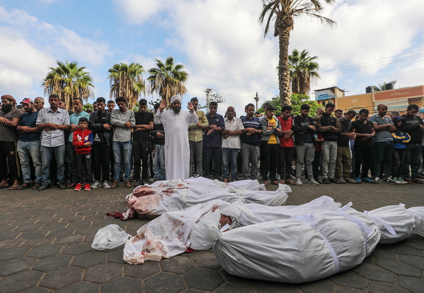 Palestinians mourn their dead following Israeli airstrikes on Gaza's Al Bureij refugee camp