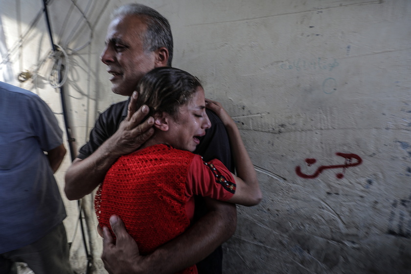 Palestinians mourn their dead following Israeli airstrikes on Gaza's Al Bureij refugee camp