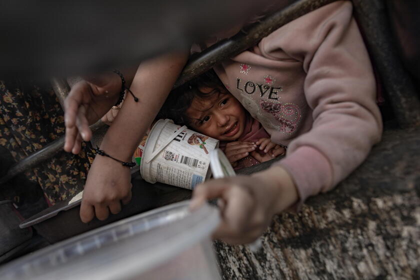 Internally displaced Palestinians gather to collect food aid in Rafah © ANSA/EPA