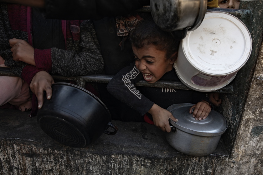 Internally displaced Palestinians gather to collect food aid in Rafah - RIPRODUZIONE RISERVATA