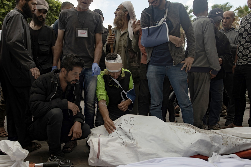 Palestinians mourn their dead after Israeli air strikes on central Gaza