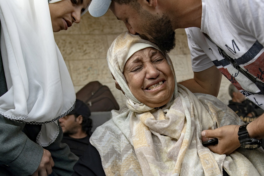 Palestinians mourn their dead after Israeli air strikes on central Gaza