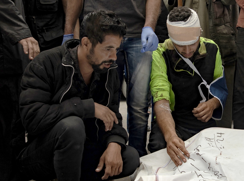 Palestinians mourn their dead after Israeli air strikes on central Gaza