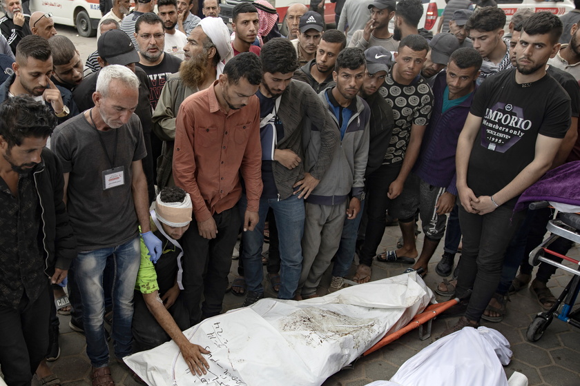 Palestinians mourn their dead after Israeli air strikes on central Gaza