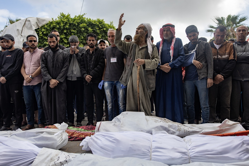 Palestinians mourn their dead after Israeli air strikes on central Gaza