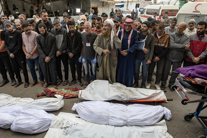 Palestinians mourn their dead after Israeli air strikes on central Gaza