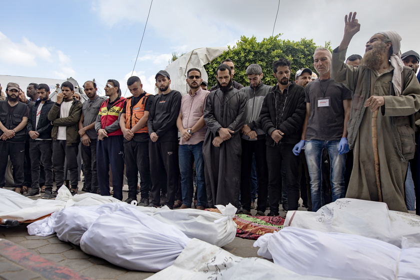 Palestinians mourn their dead after Israeli air strikes on central Gaza