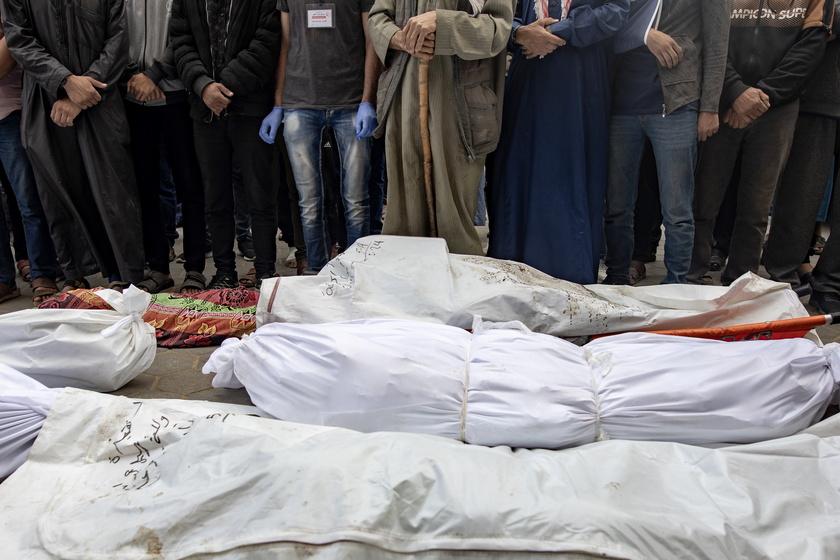 Palestinians mourn their dead after Israeli air strikes on central Gaza