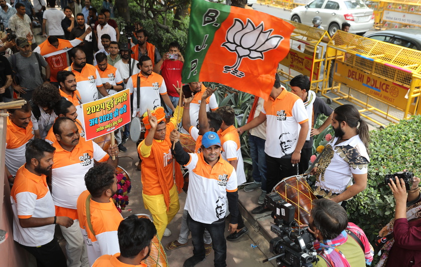 Bharatiya Janata Party supporters celebrate party lead in the election