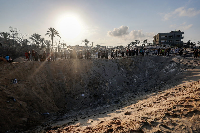 Palestinians search for missing people following Israeli airstrikes on Al-Mawasi humanitarian zone