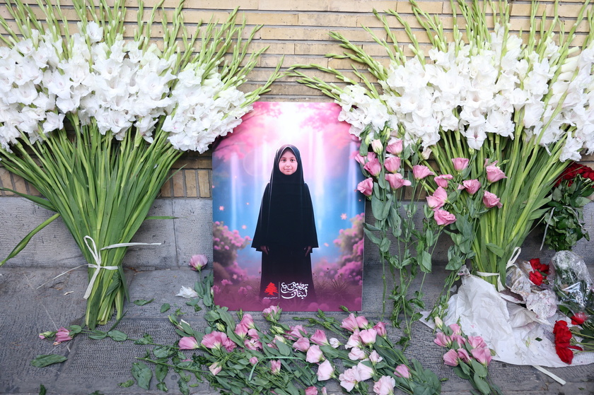 Iranians lay flowers in front of the Lebanese embassy in Tehran