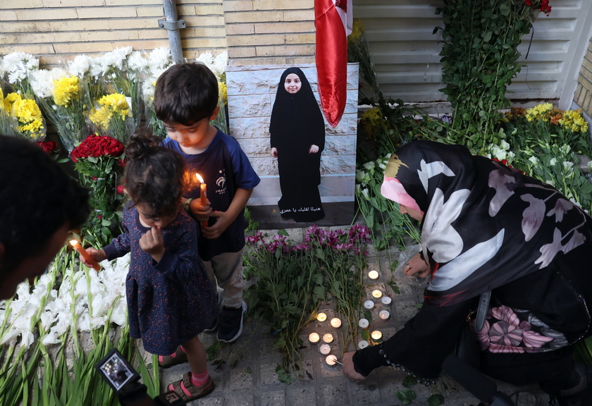 Iranians lay flowers in front of the Lebanese embassy in Tehran