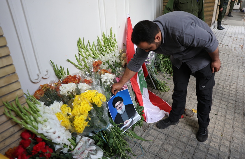 Iranians lay flowers in front of the Lebanese embassy in Tehran