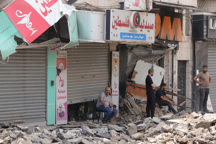 Palestinians inspect the damage after a 10-day Israeli military operation in West Bank's Jenin