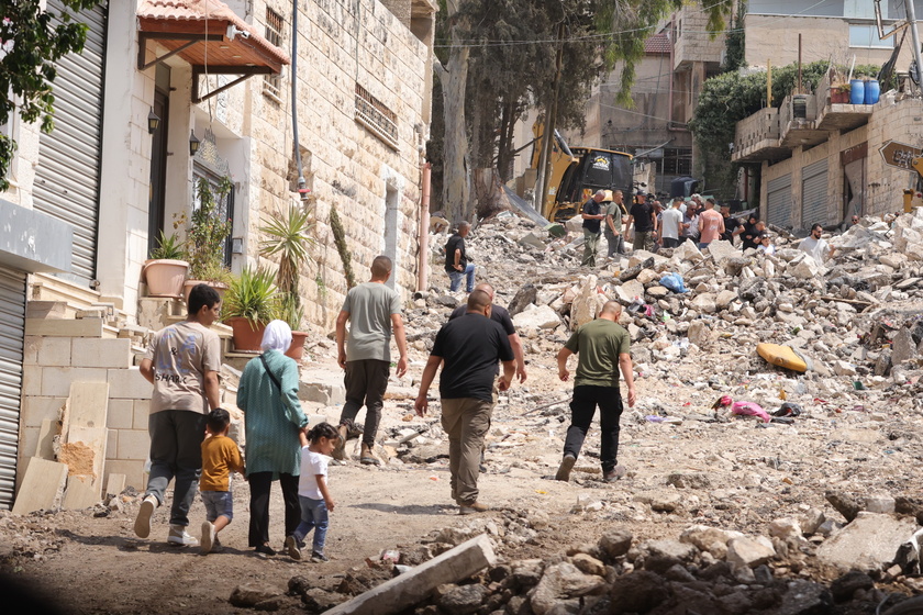 Palestinians inspect the damage after a 10-day Israeli military operation in West Bank's Jenin